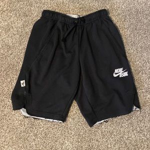 Medium black Nike baseball shorts.